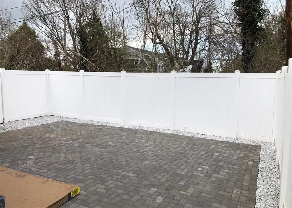 65 Louis Street, Unit A Barnstable, MA 02601 - Photo 24 of 28 a view of wooden floor and trees in the background
