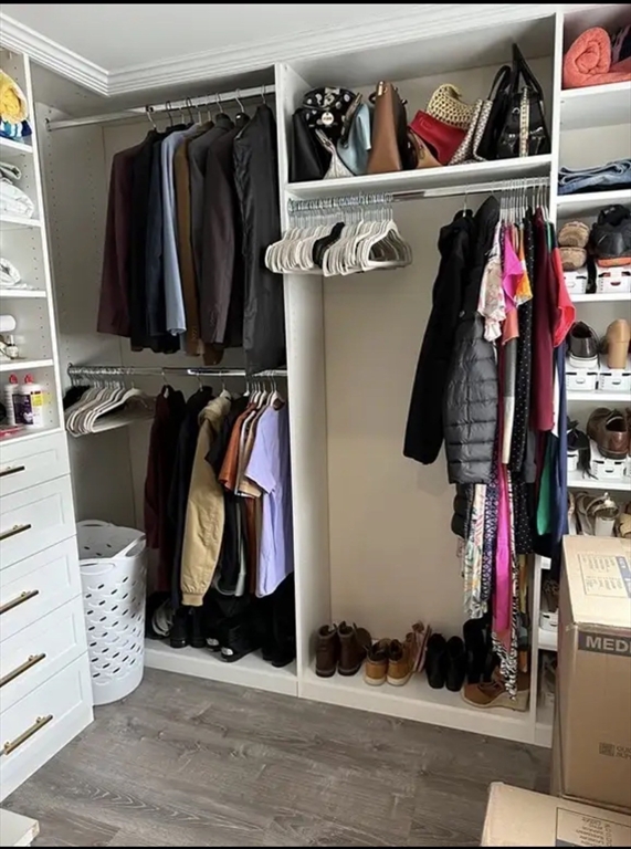 65 Louis Street, Unit A Barnstable, MA 02601 - Photo 27 of 28 a view of walk in closet with clothes and shoes