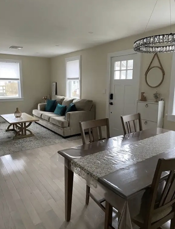 65 Louis Street, Unit A Barnstable, MA 02601 - Photo 5 of 28 a view of a dining room with furniture window and wooden floor