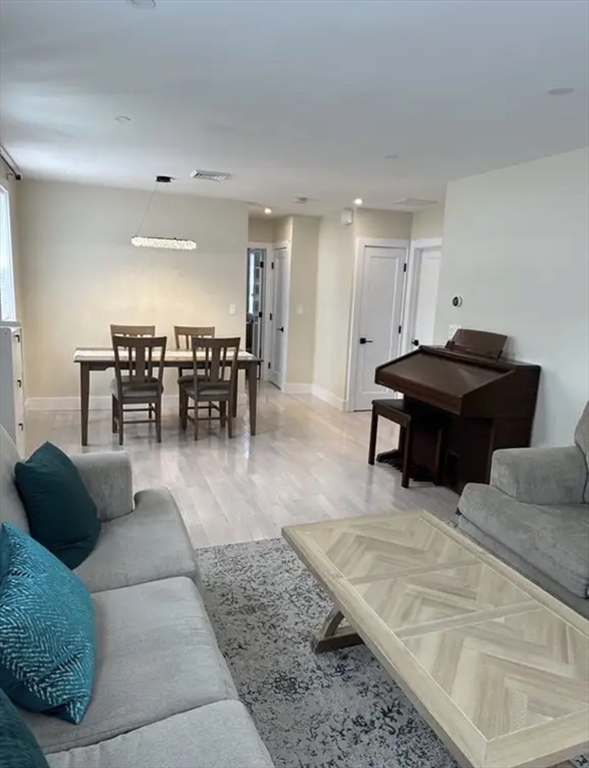 65 Louis Street, Unit A Barnstable, MA 02601 - Photo 6 of 28 a living room with furniture a dining table and a piano table