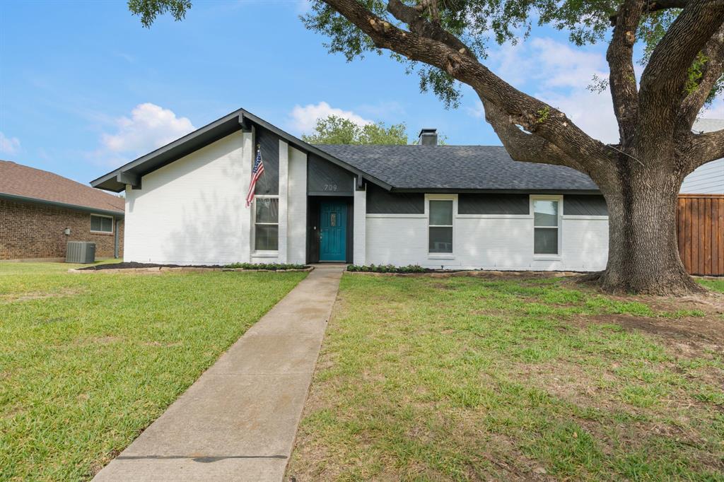 709 Reno Street Lewisville, TX 75077 - Photo 1 of 1 a front view of a house with garden