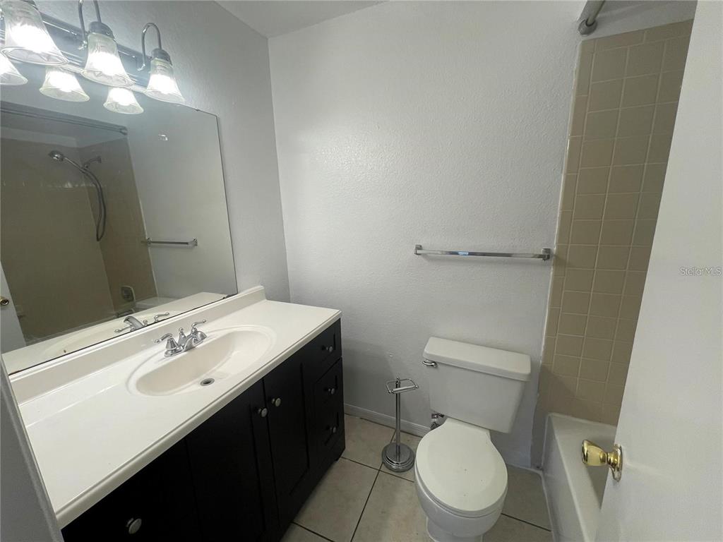 1027 South Hiawassee Road, Unit 2323 Orlando, FL 32835 - Photo 13 of 20 a bathroom with a toilet a sink and mirror