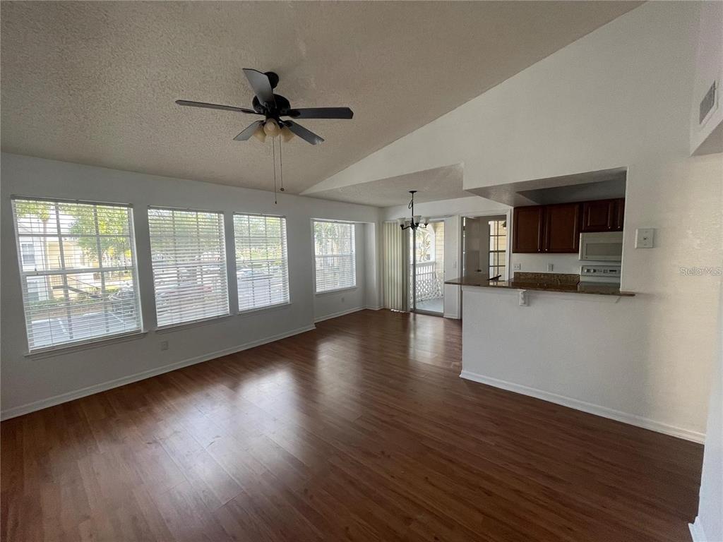 1027 South Hiawassee Road, Unit 2323 Orlando, FL 32835 - Photo 3 of 20 a view of a kitchen with a dishwasher cabinets and a floor to ceiling window