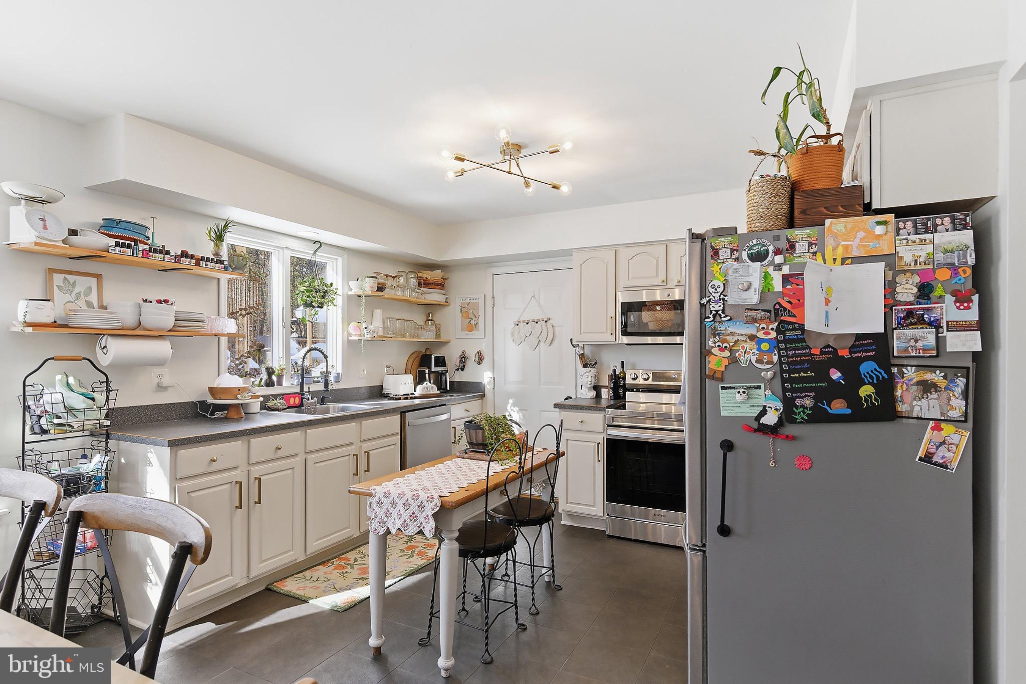 128 Highway 72 Vincentown, NJ 08088 - Photo 13 of 32 a kitchen with stainless steel appliances kitchen island granite countertop a refrigerator and microwave