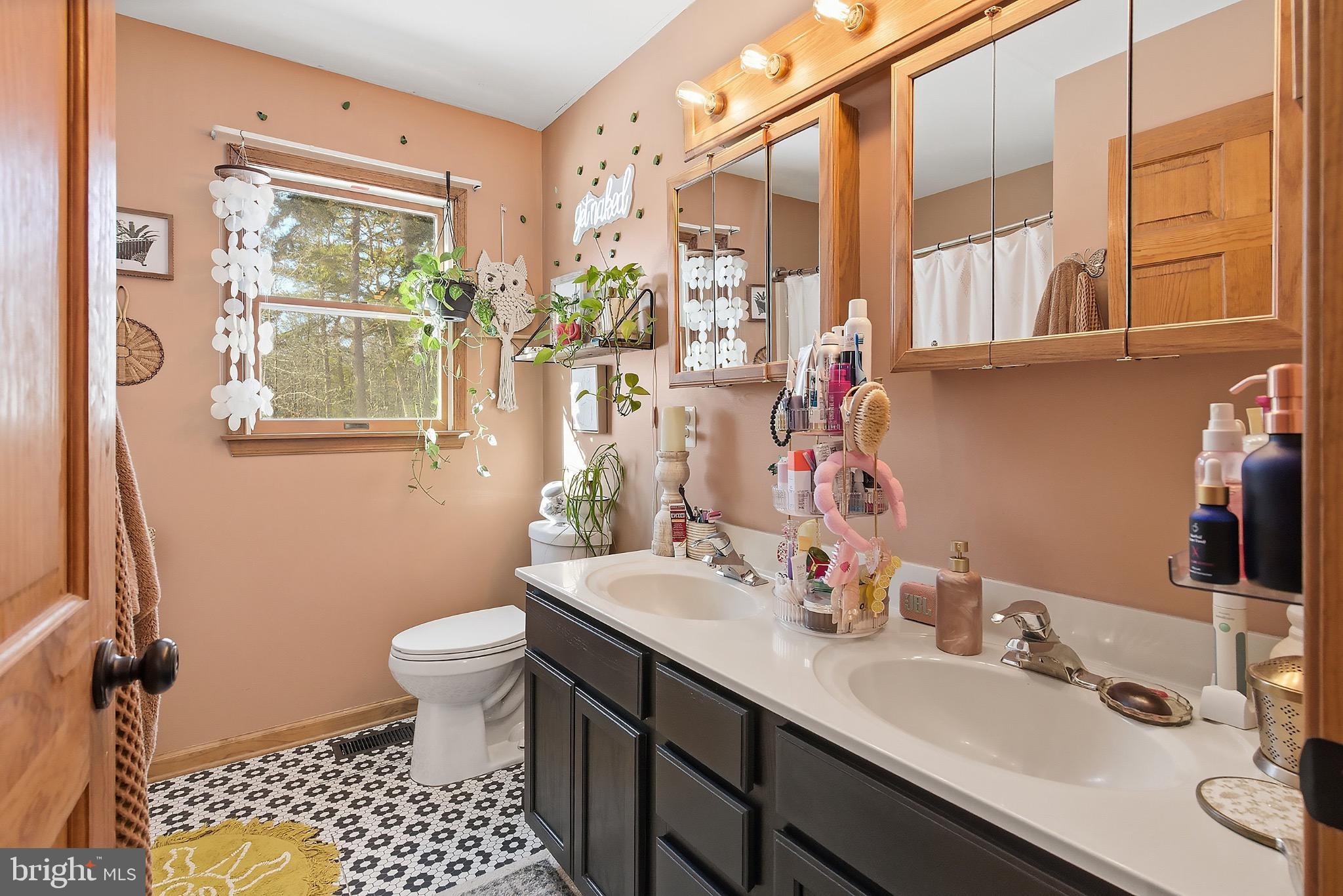 128 Highway 72 Vincentown, NJ 08088 - Photo 24 of 32 a bathroom with a sink toilet a mirror and next to a window