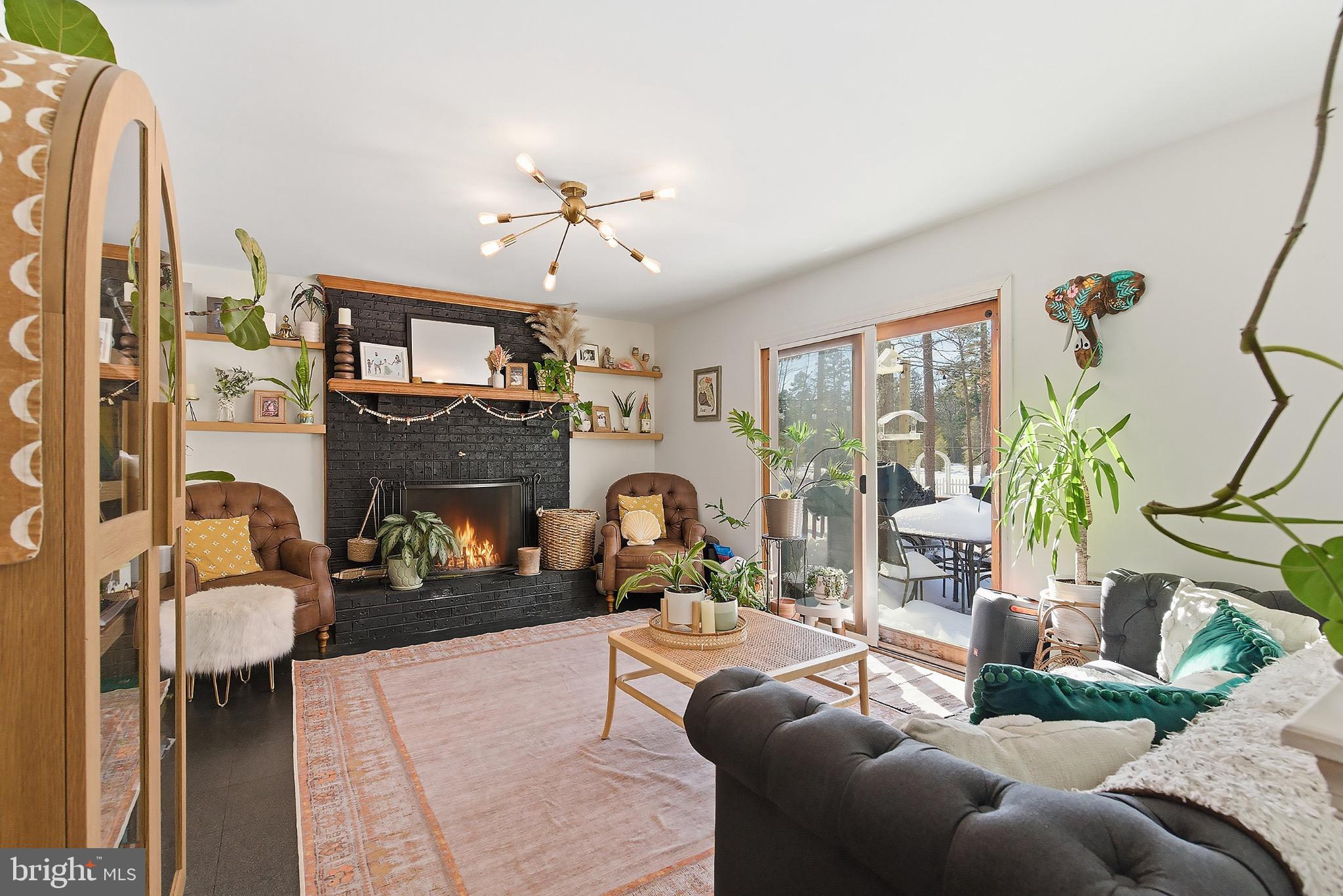 128 Highway 72 Vincentown, NJ 08088 - Photo 10 of 32 a living room with furniture a fireplace and a floor to ceiling window