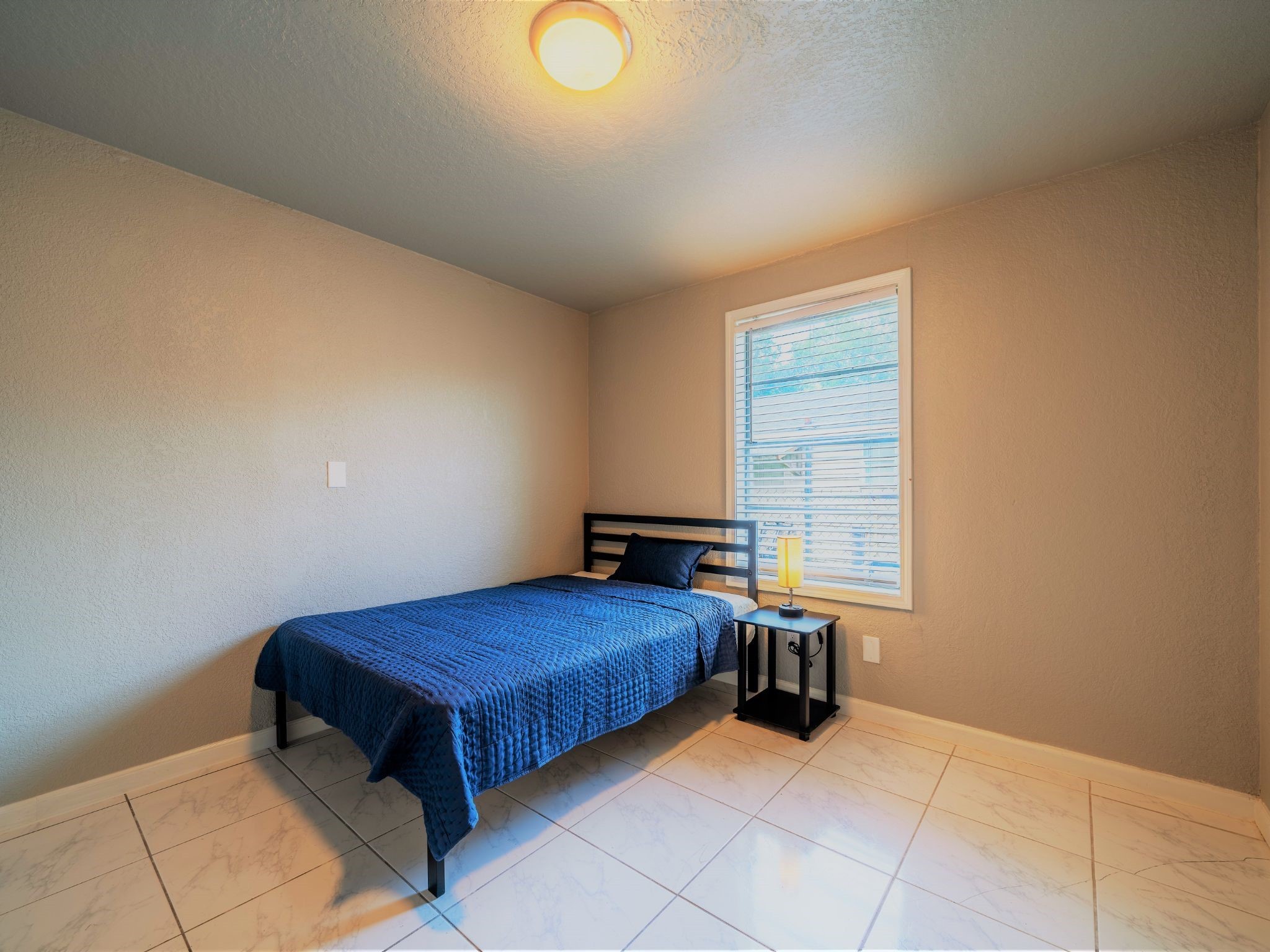 428 Gans Street Houston, TX 77029 - Photo 15 of 23 This corner bedroom offers privacy and warmth, enhanced by detailed trim work and elegant flooring.