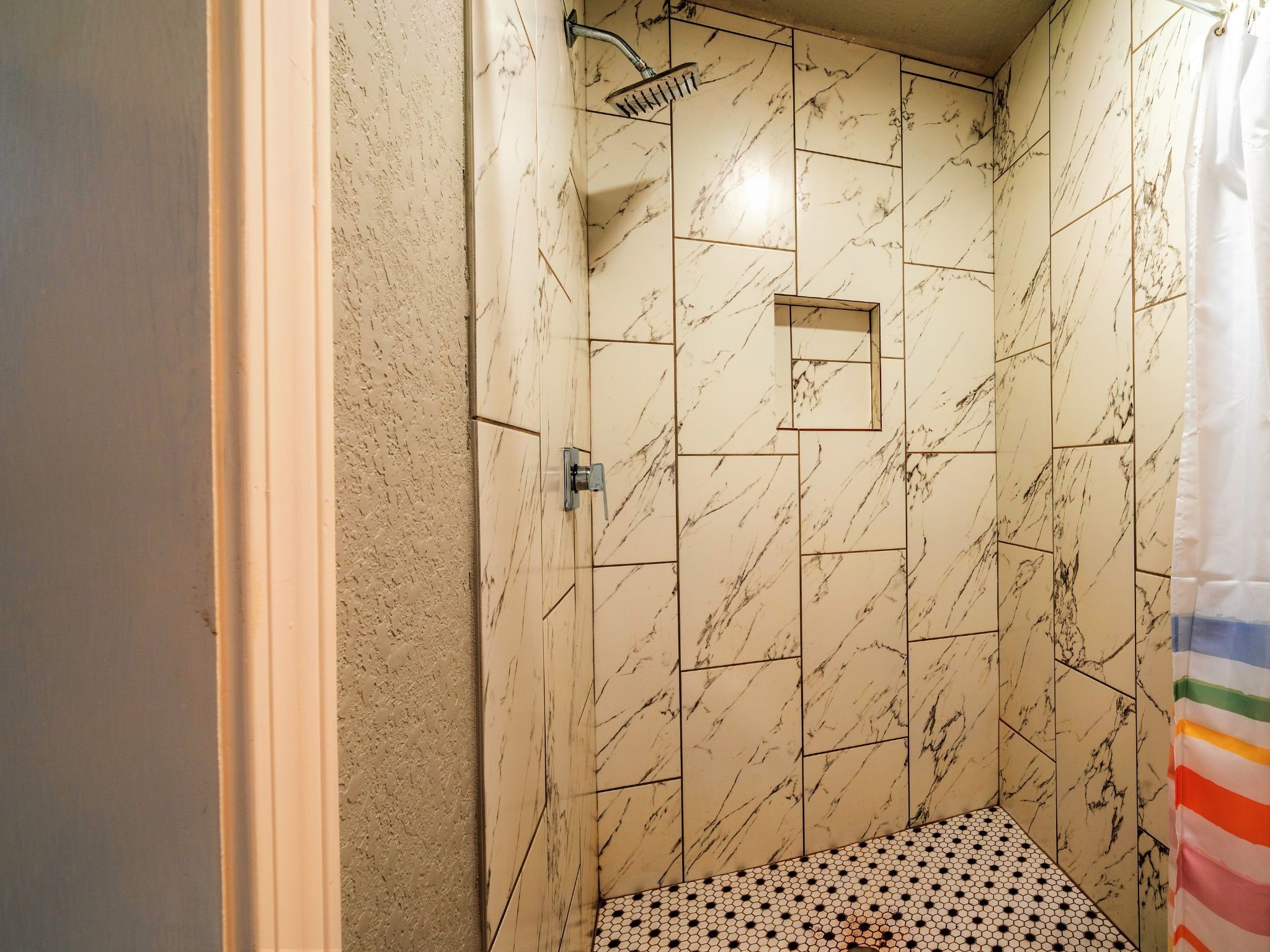 428 Gans Street Houston, TX 77029 - Photo 10 of 23 Stunning walk-in shower with designer tile, upgraded fixtures, and glass accents. A true standout feature.