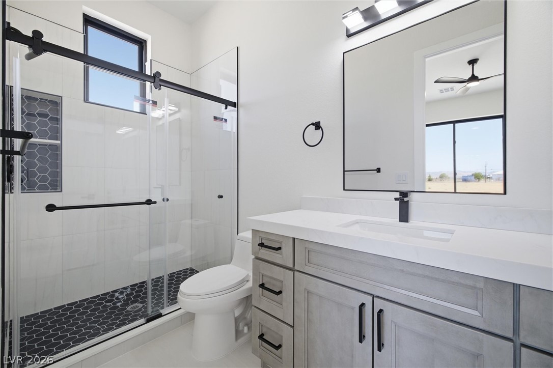 5910 East Kellogg Road Pahrump, NV 89061 - Photo 26 of 58 A well-appointed bathroom with a spacious walk-in shower and modern vanity.