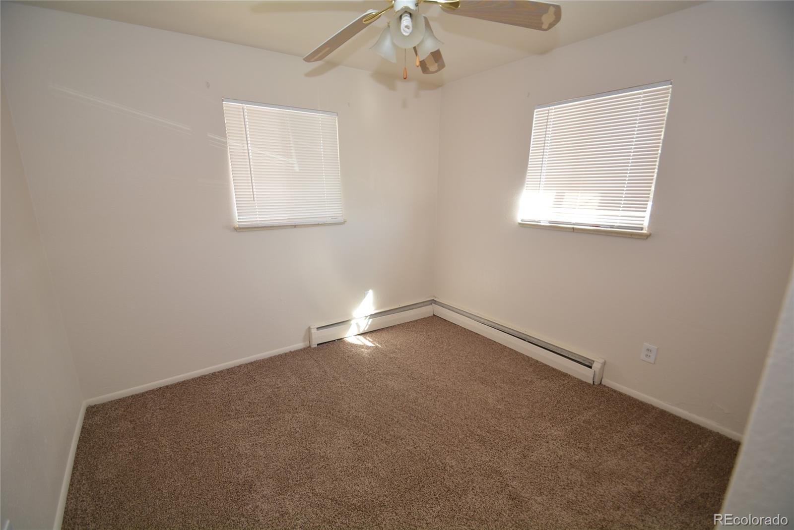 4510 Flower Street Wheat Ridge, CO 80033 - Photo 4 of 5 an empty room with a window