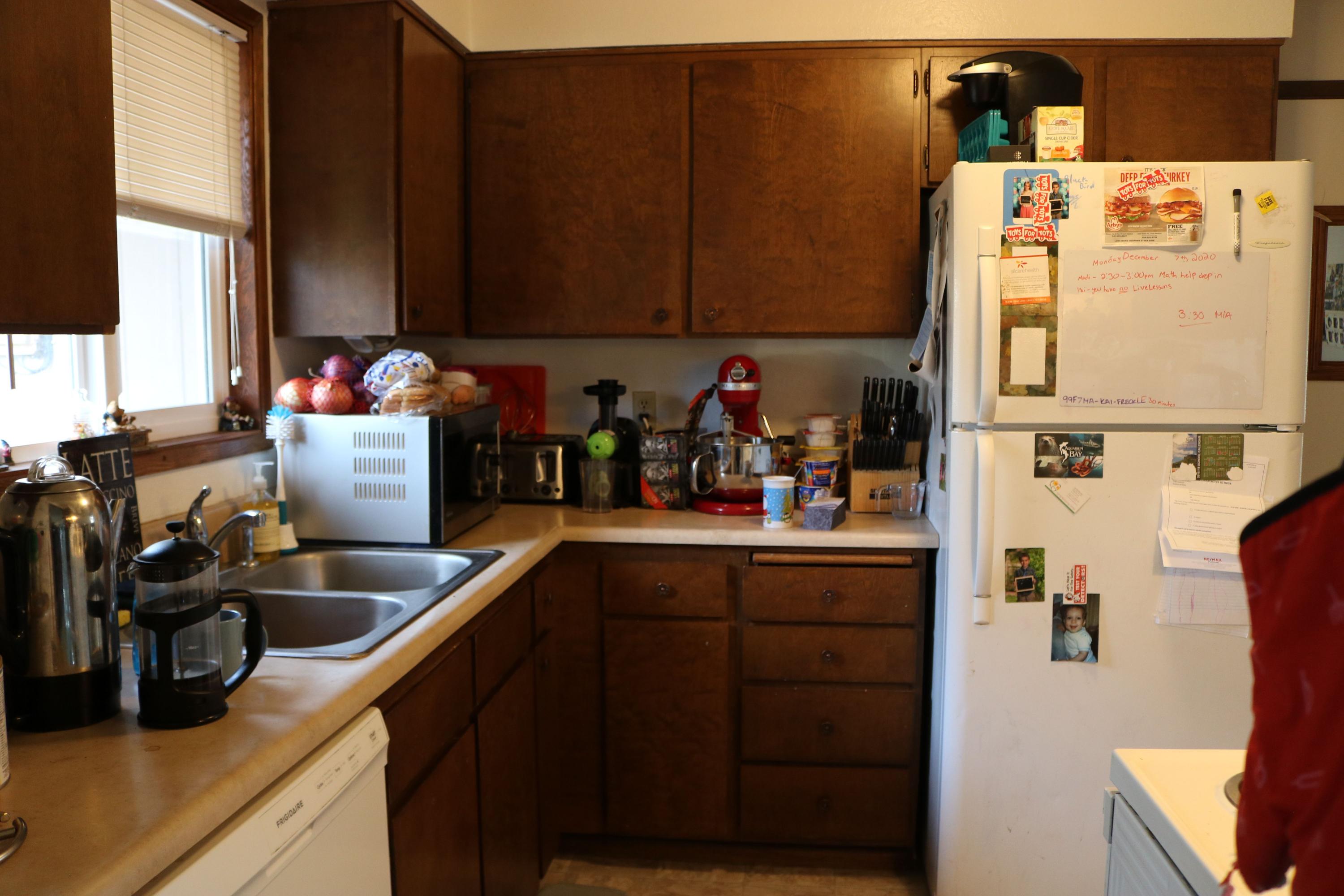 2180 Crestbrook Road Medford, OR 97504 - Photo 5 of 10 a kitchen with refrigerator and cabinets