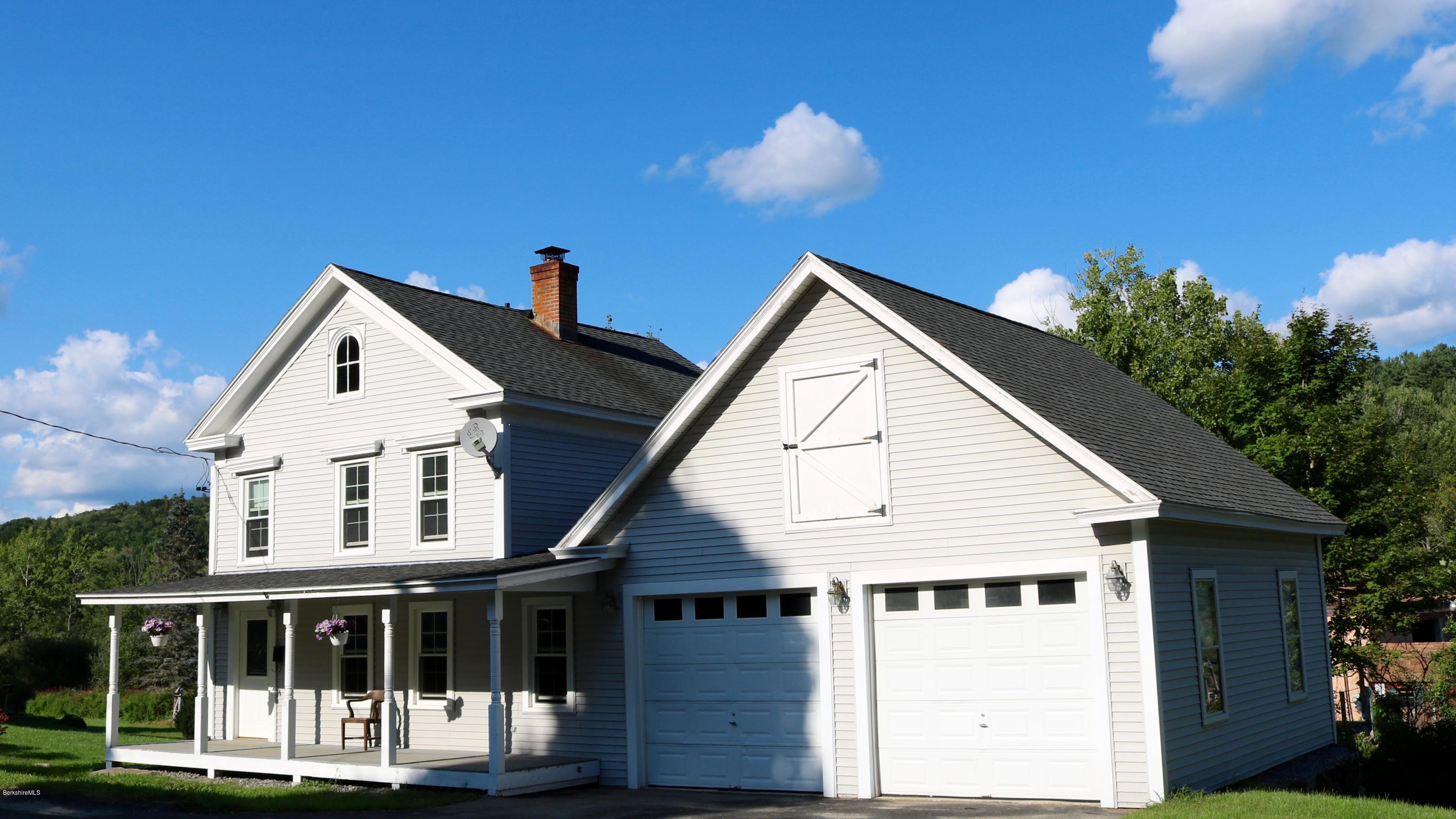 a view of house with a yard and front view of a house
