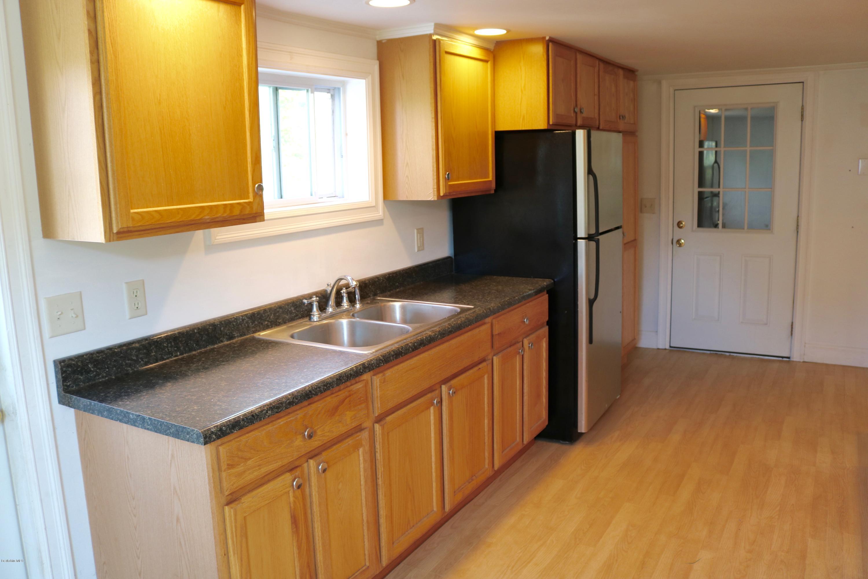 87 South Main Road Otis, MA 01253 - Photo 14 of 35 a kitchen with stainless steel appliances granite countertop a sink and a refrigerator