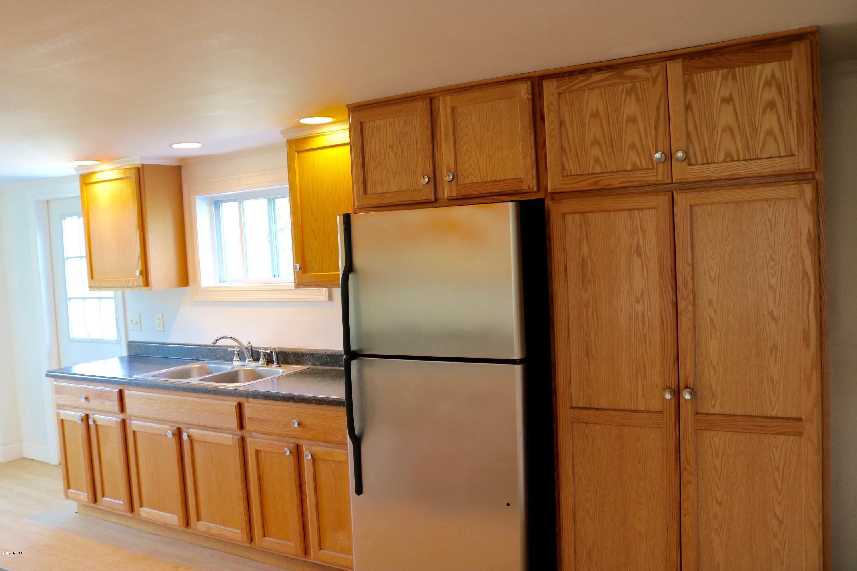 87 South Main Road Otis, MA 01253 - Photo 16 of 35 a kitchen with a refrigerator a sink and cabinets