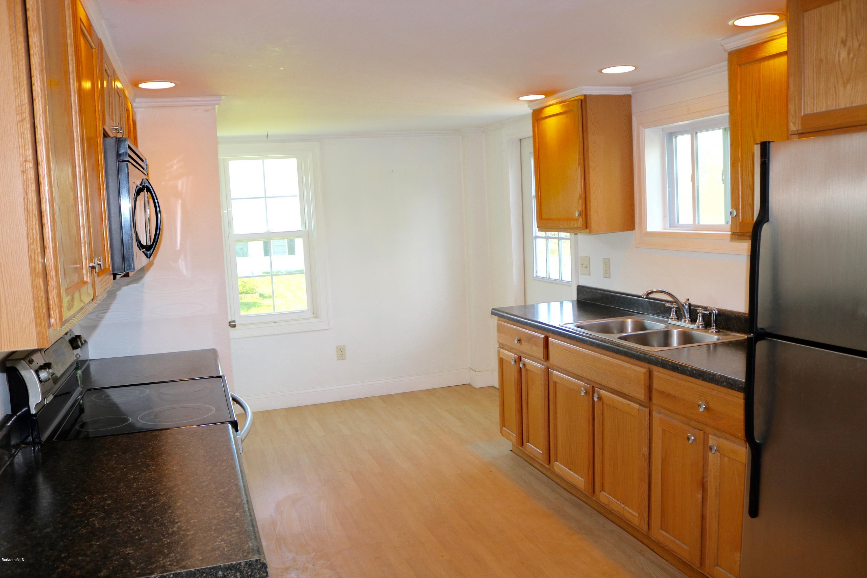 87 South Main Road Otis, MA 01253 - Photo 17 of 35 a kitchen with stainless steel appliances granite countertop a sink a stove and a refrigerator