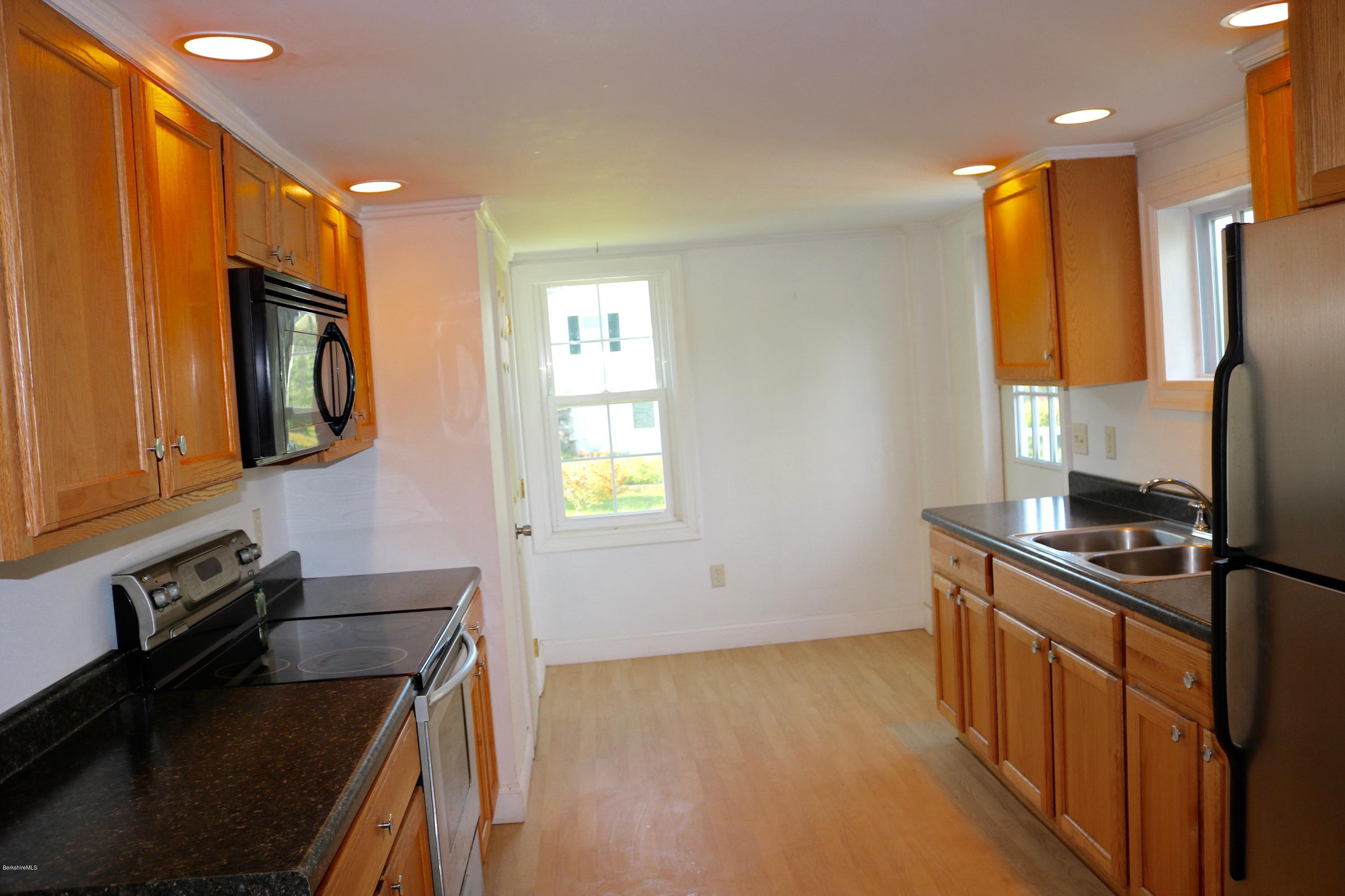 87 South Main Road Otis, MA 01253 - Photo 18 of 35 a kitchen with stainless steel appliances a stove microwave and refrigerator