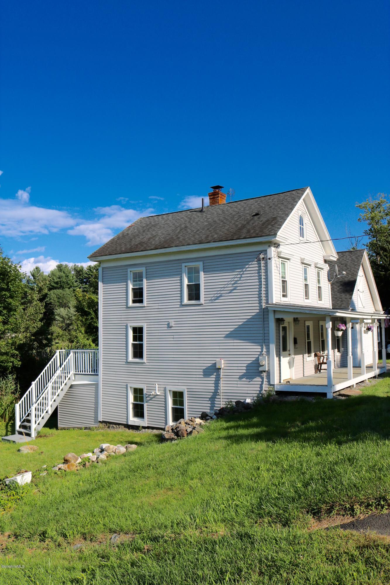 87 South Main Road Otis, MA 01253 - Photo 4 of 35 a front view of a house with a yard