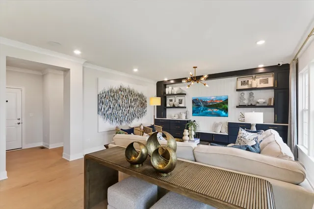 a living room with furniture and a painting on the wall