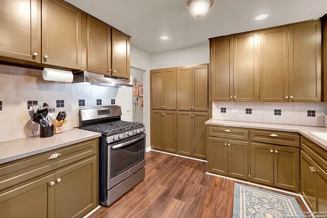 a kitchen with a sink stove and refrigerator