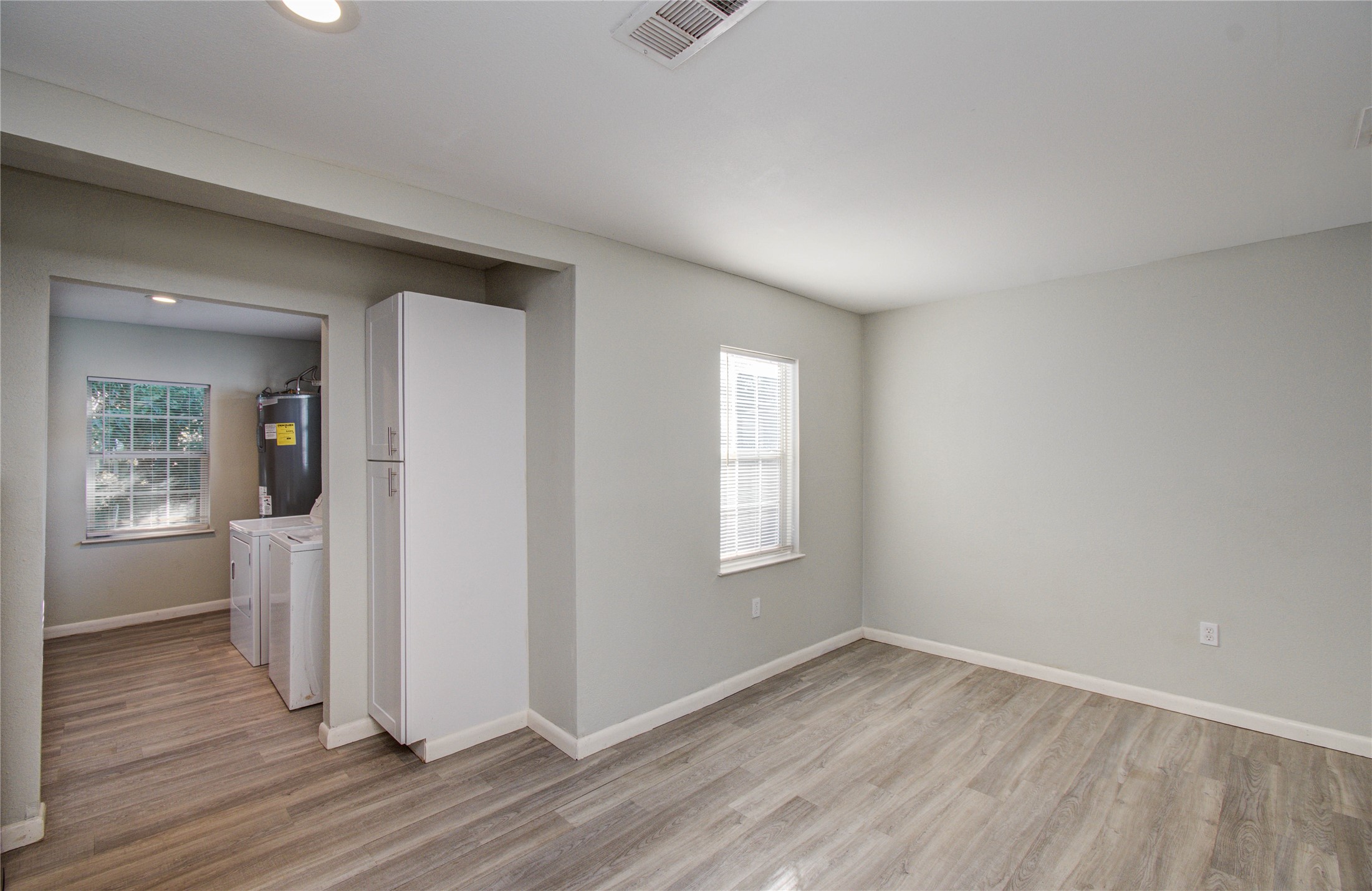 4624 Kingsbury Street Houston, TX 77021 - Photo 11 of 31 an empty room with wooden floor and windows