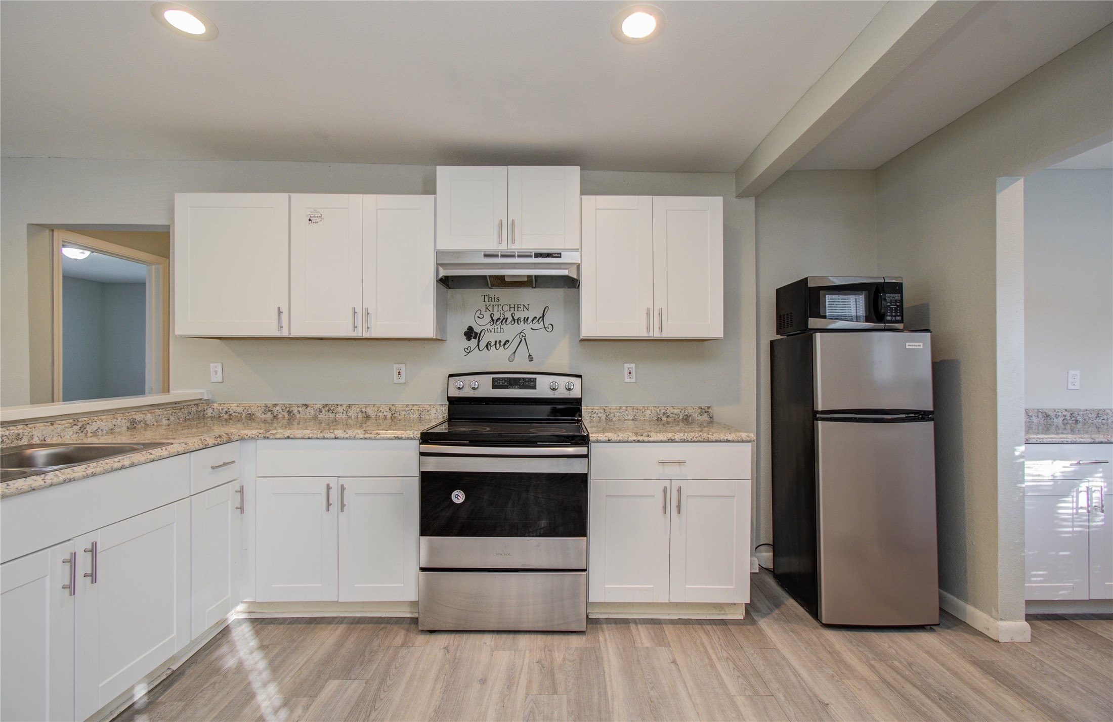 4624 Kingsbury Street Houston, TX 77021 - Photo 12 of 31 a kitchen with white cabinets and stainless steel appliances