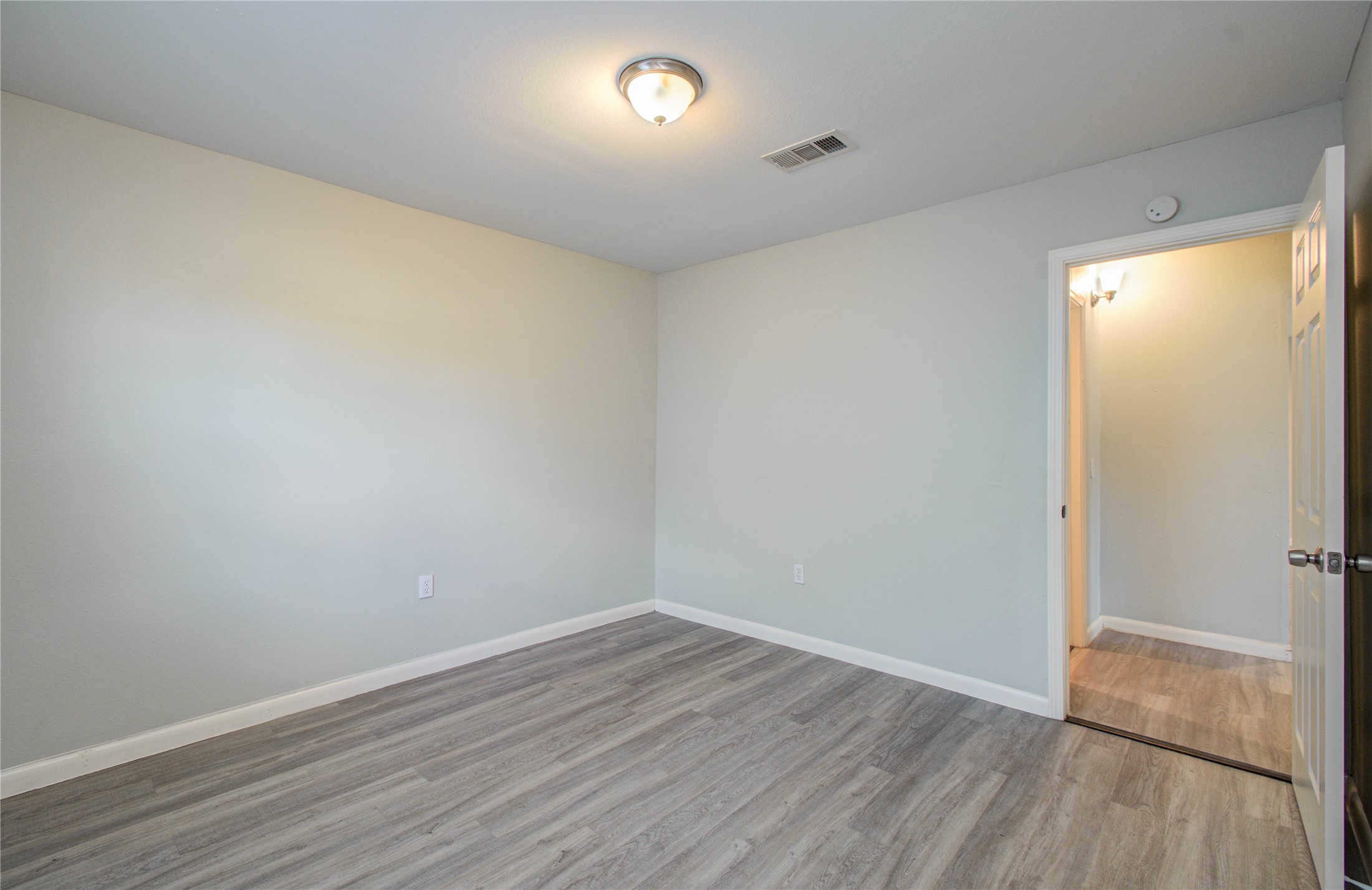 4624 Kingsbury Street Houston, TX 77021 - Photo 25 of 31 a view of an empty room with wooden floor and a window