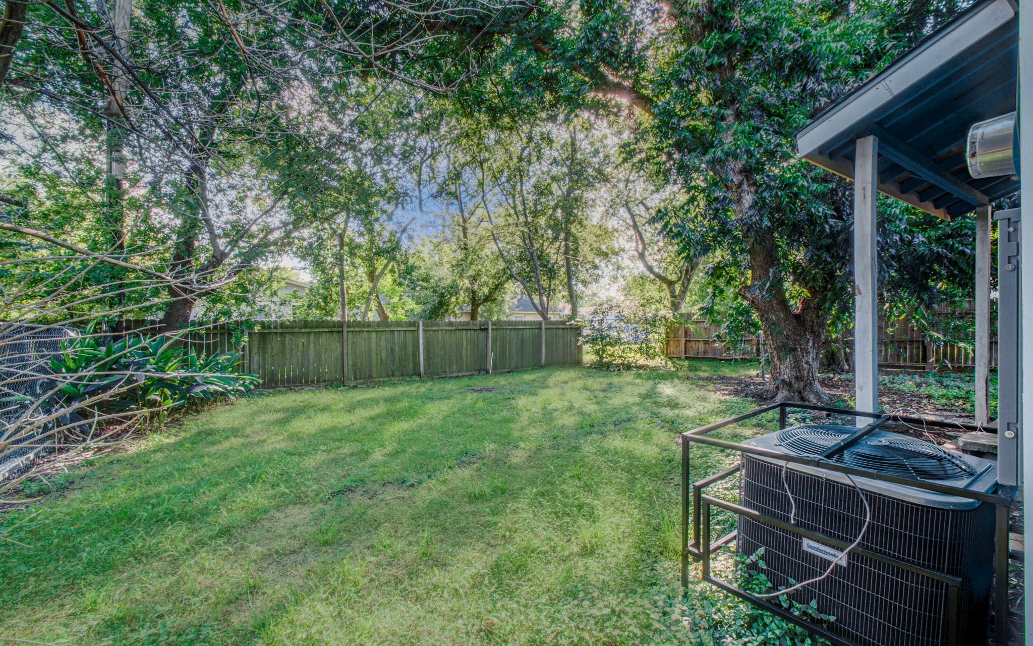 4624 Kingsbury Street Houston, TX 77021 - Photo 29 of 31 a view of a backyard with couches plants and large tree