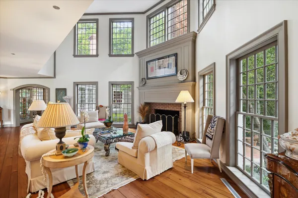 a living room with furniture a fireplace and a large window