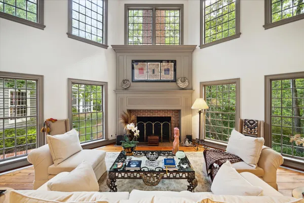 a living room with furniture large window and a fireplace