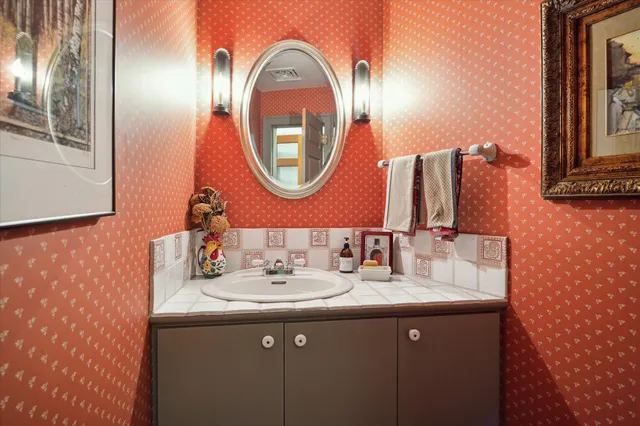 a bathroom with a sink and a mirror