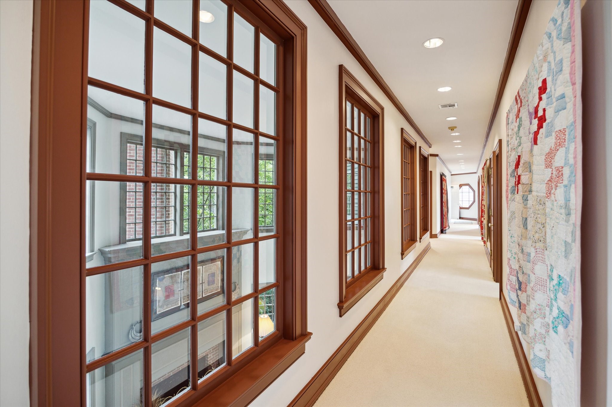 3971 Inverness Drive Houston, TX 77019 - Photo 35 of 50 a view of a hallway with wooden floor and windows