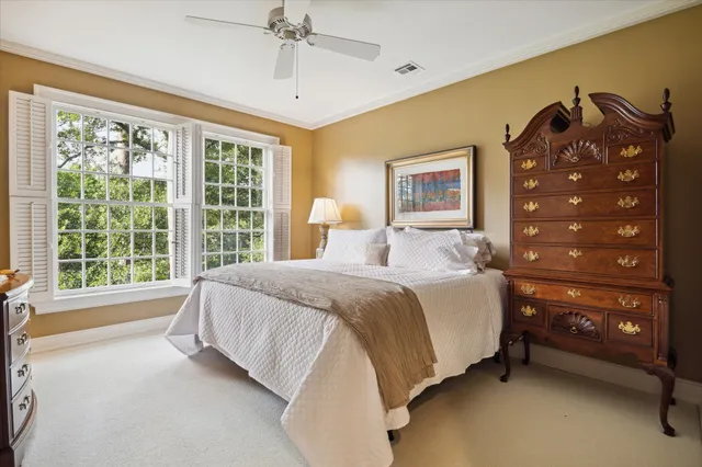 a spacious bedroom with a bed and a window