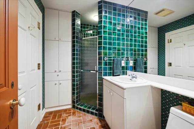 a room with a sink and a large mirror