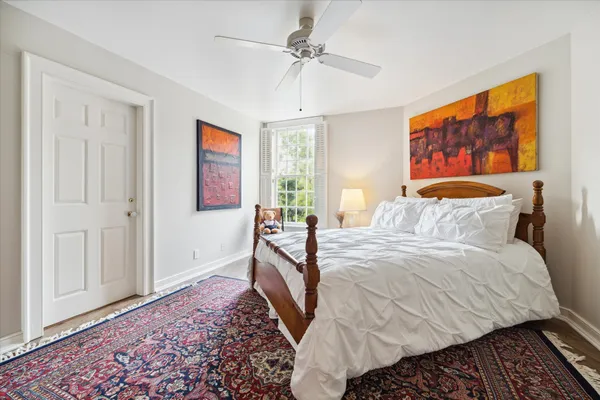 a bedroom with a bed and a painting on the wall