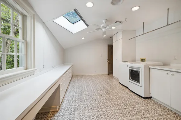 a view of an empty room with a fireplace and a window