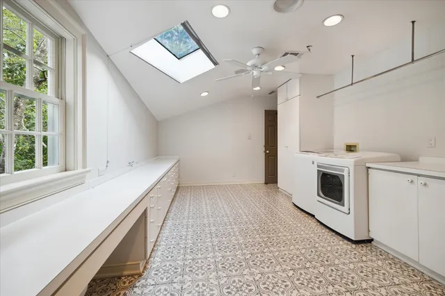 a view of an empty room with a fireplace and a window
