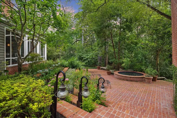 a view of a patio with chairs and plants