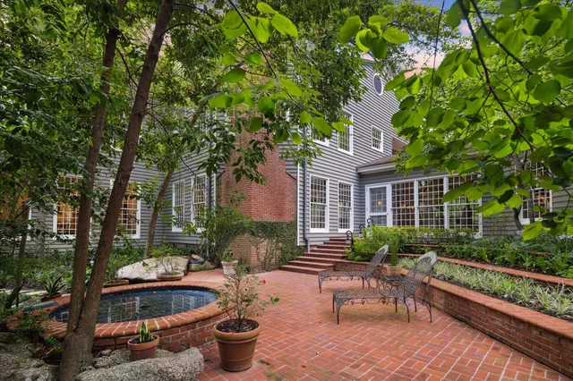 a front view of a house with swimming pool and sitting area