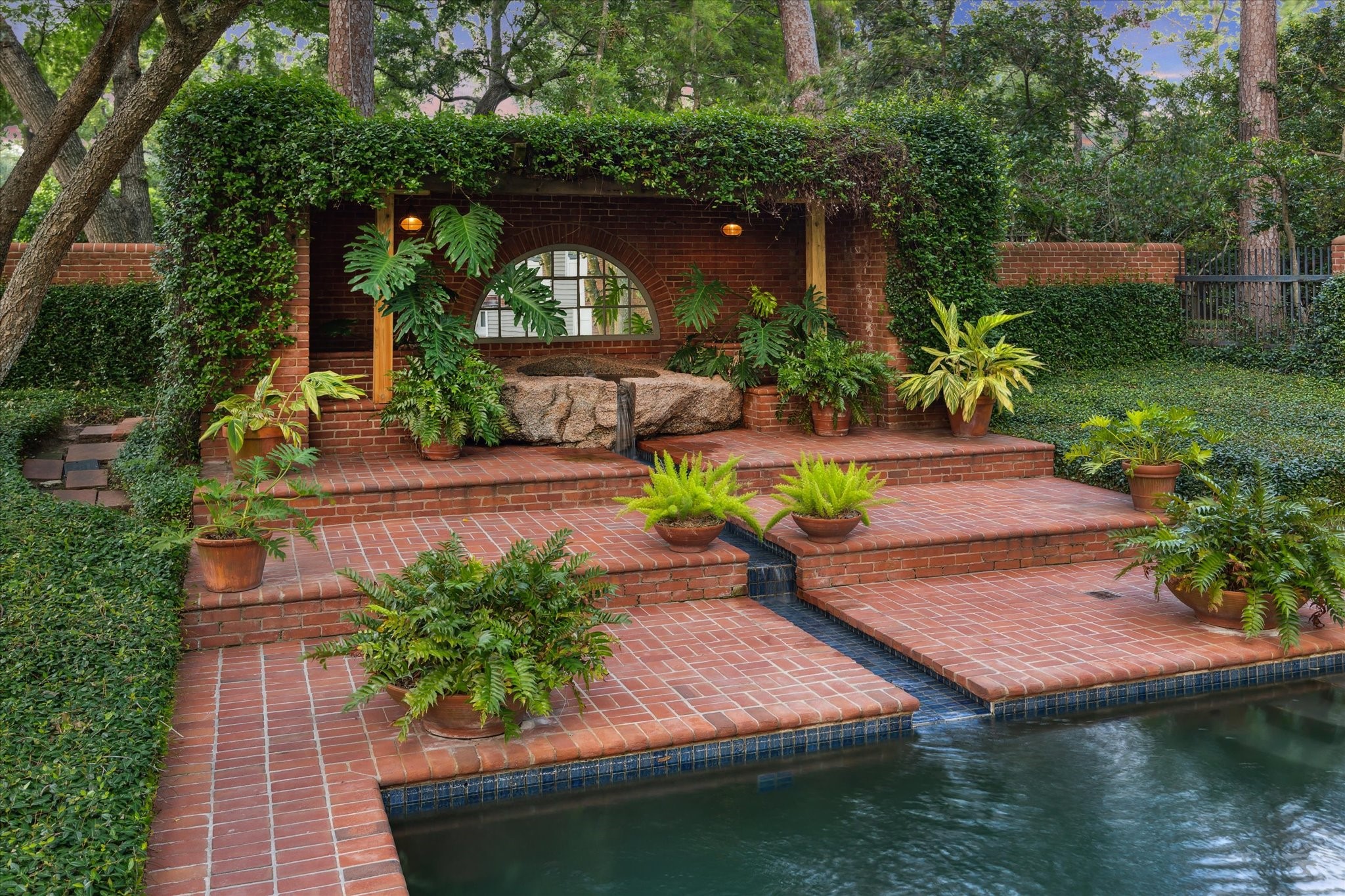 3971 Inverness Drive Houston, TX 77019 - Photo 47 of 50 a view of a backyard with plants and a patio