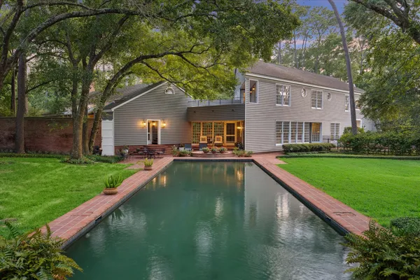 a view of a house with a yard patio and swimming pool