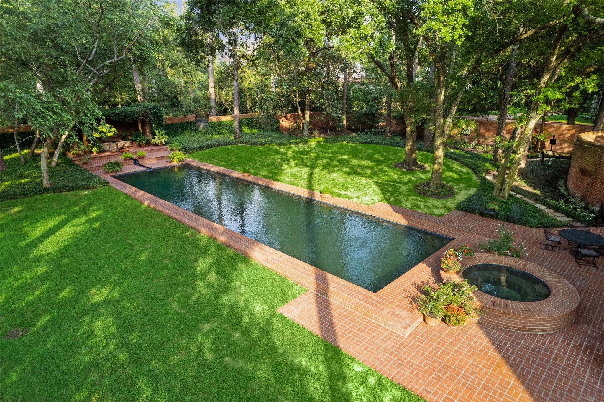 3971 Inverness Drive Houston, TX 77019 - Photo 5 of 50 a view of a swimming pool with a patio and a garden