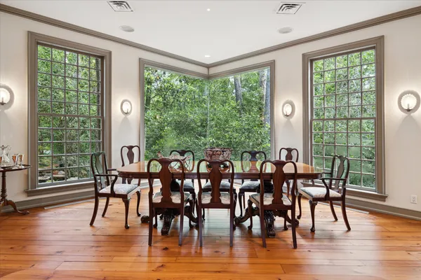 a view of a dining room with furniture window and wooden floor