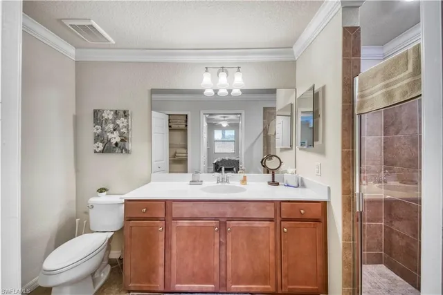 a bathroom with a granite countertop sink toilet a large mirror and shower