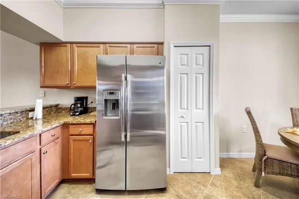 a kitchen with a refrigerator and cabinets