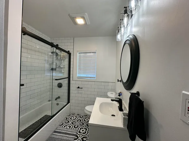 a bathroom with a sink toilet and shower