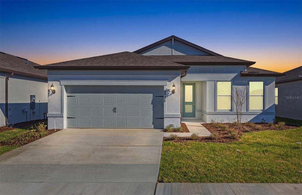 6933 Southwest 90th Place Ocala, FL 34476 - Photo 17 of 17 a front view of a house with a yard
