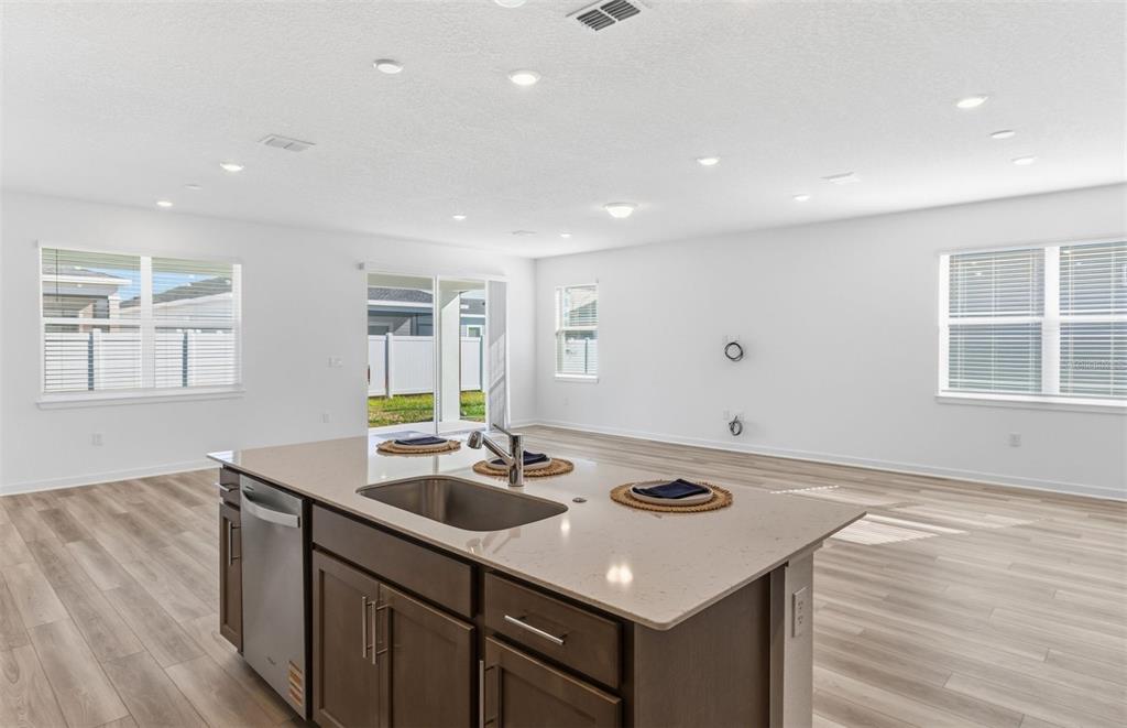 6933 Southwest 90th Place Ocala, FL 34476 - Photo 4 of 17 a kitchen with a sink cabinets and wooden floor