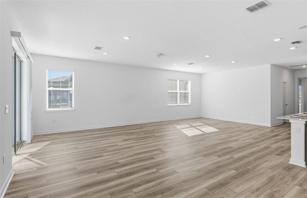 6933 Southwest 90th Place Ocala, FL 34476 - Photo 5 of 17 a view of empty room with wooden floor and fan