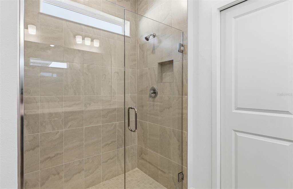 6933 Southwest 90th Place Ocala, FL 34476 - Photo 8 of 17 a bathroom with a glass shower door