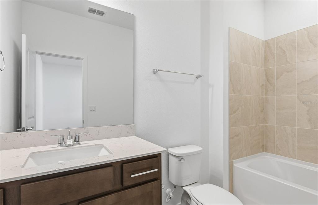 6933 Southwest 90th Place Ocala, FL 34476 - Photo 10 of 17 a bathroom with a sink toilet vanity and shower